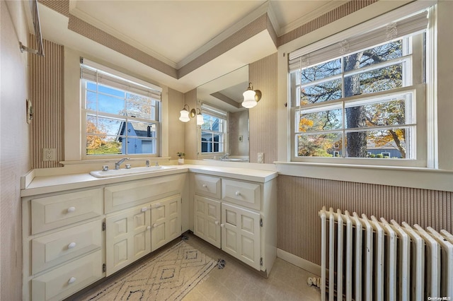 bathroom with vanity, radiator heating unit, and crown molding