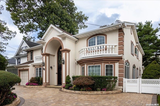 view of front facade featuring a balcony and a garage