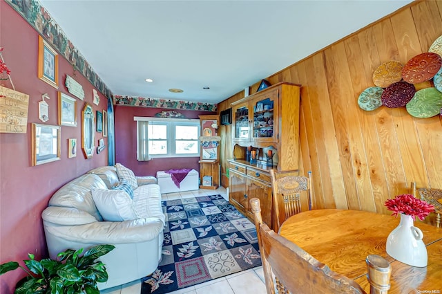 tiled living room featuring wooden walls