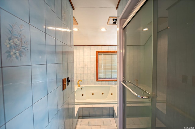 bathroom featuring tile patterned flooring, separate shower and tub, and tile walls