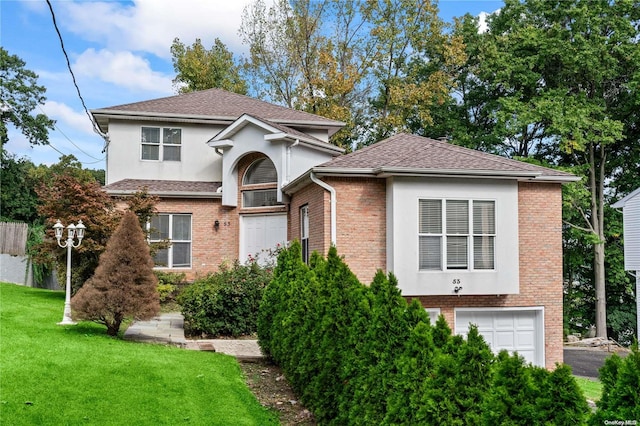 view of front of house with a garage and a front lawn