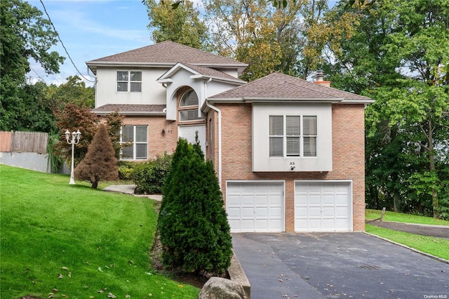 front facade featuring a garage and a front lawn