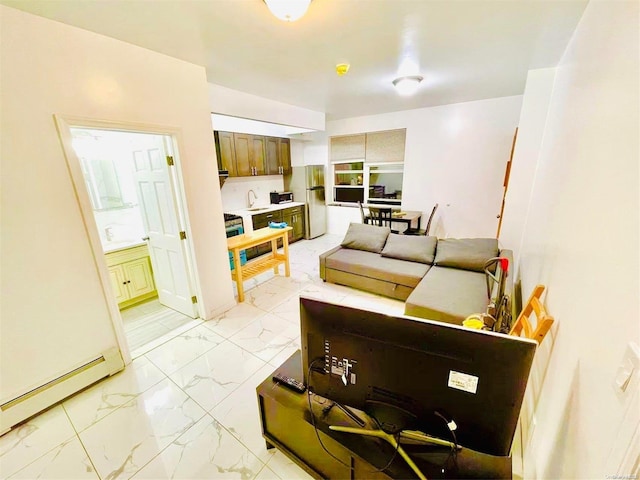 living room featuring a baseboard radiator and sink