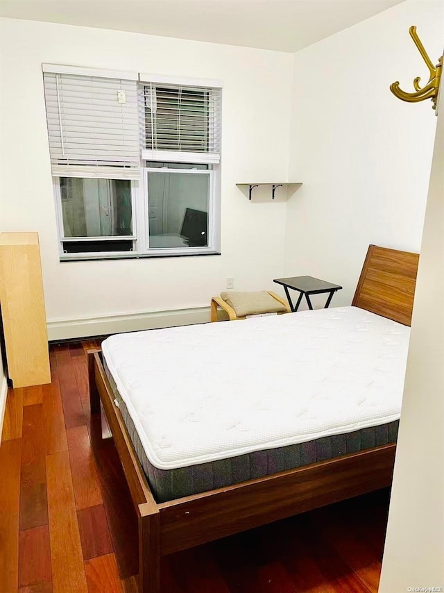 bedroom with dark wood-type flooring