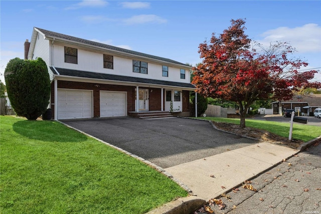 view of front property with a garage and a front yard