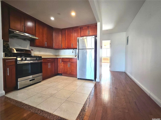 kitchen featuring stainless steel appliances and light hardwood / wood-style flooring