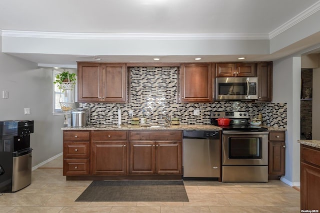 kitchen with light stone countertops, sink, crown molding, decorative backsplash, and appliances with stainless steel finishes