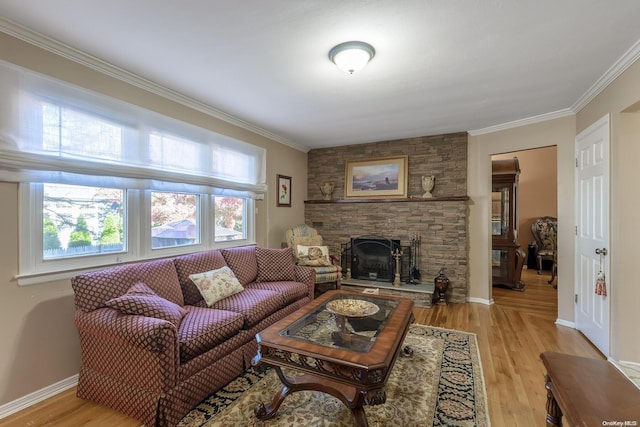 living room with baseboards, a fireplace, light wood-type flooring, and ornamental molding