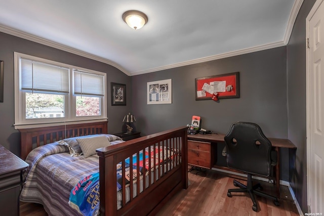 bedroom featuring wood-type flooring, lofted ceiling, and crown molding