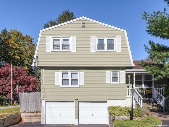 view of front of property featuring a gambrel roof and an attached garage