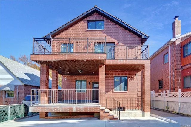 rear view of house featuring a balcony