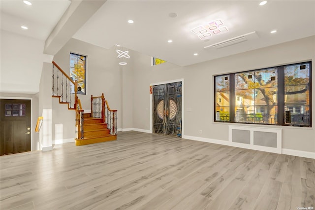 unfurnished living room featuring light wood-type flooring