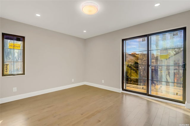 unfurnished room with light hardwood / wood-style floors