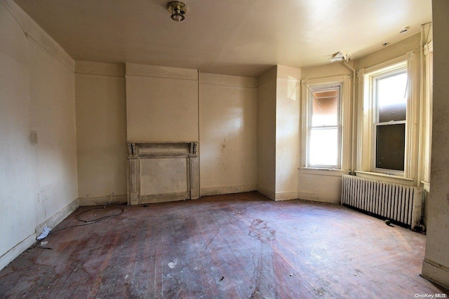 empty room featuring hardwood / wood-style floors and radiator