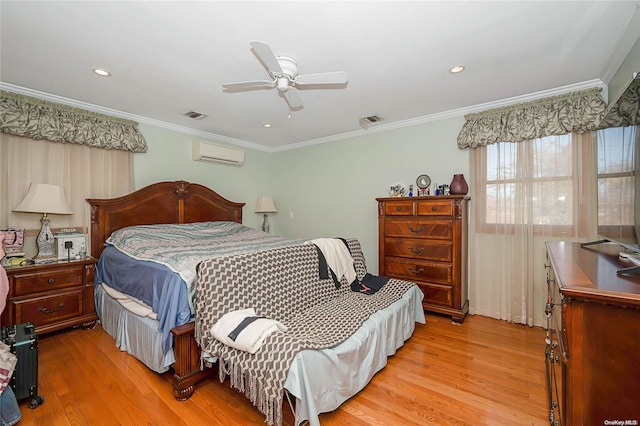 bedroom with an AC wall unit, ceiling fan, crown molding, and light hardwood / wood-style floors