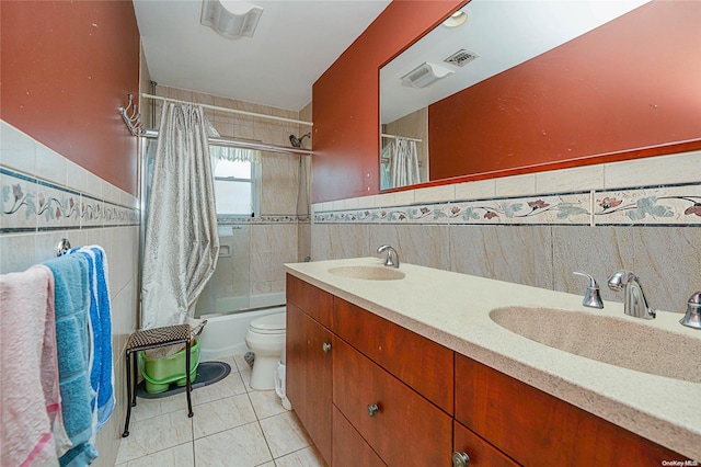 full bathroom featuring shower / bath combo, vanity, tile patterned floors, toilet, and tile walls