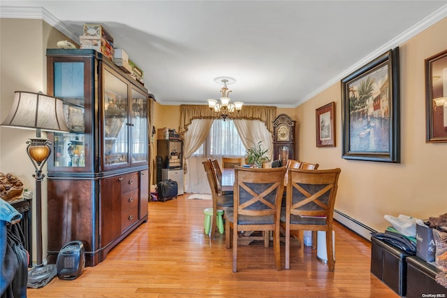 dining space featuring ornamental molding, light wood-type flooring, an inviting chandelier, and a baseboard heating unit