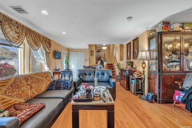 living room featuring crown molding and hardwood / wood-style floors