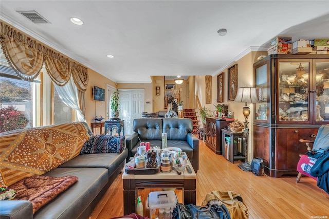 living room with wood-type flooring and crown molding