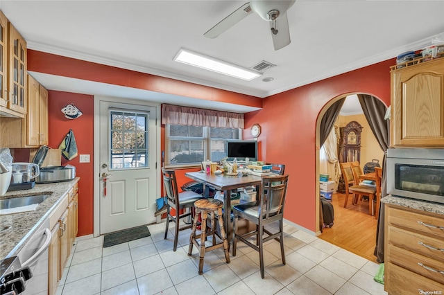 dining area with light hardwood / wood-style flooring, ceiling fan, ornamental molding, and sink