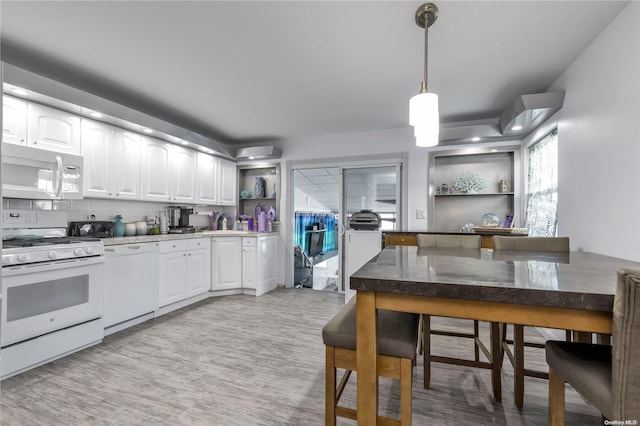 kitchen featuring pendant lighting, white appliances, white cabinetry, and backsplash