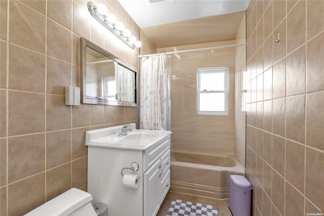 full bathroom with vanity, tile patterned floors, toilet, tile walls, and shower / tub combo with curtain