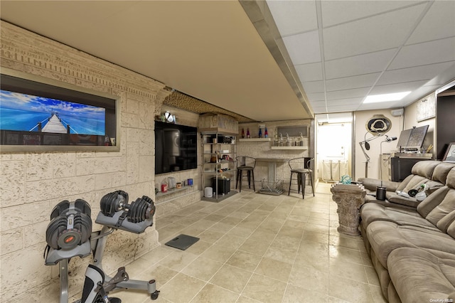 interior space featuring bar area, a paneled ceiling, and light tile patterned floors