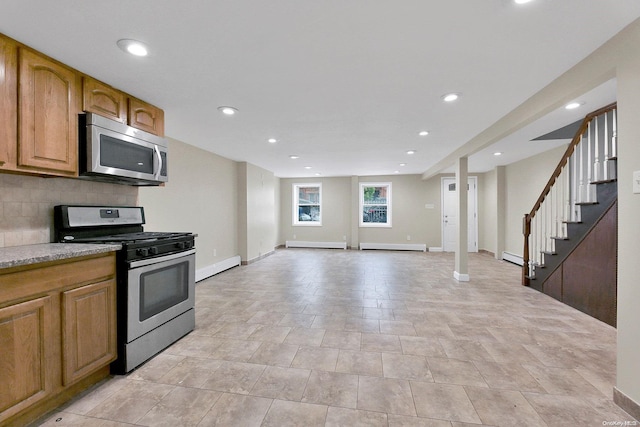 kitchen with baseboard heating, decorative backsplash, and stainless steel appliances