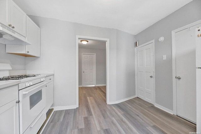 kitchen with white cabinetry, gas range gas stove, extractor fan, and light wood-type flooring