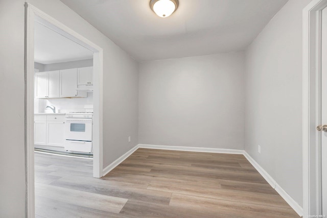 unfurnished room with light wood-type flooring