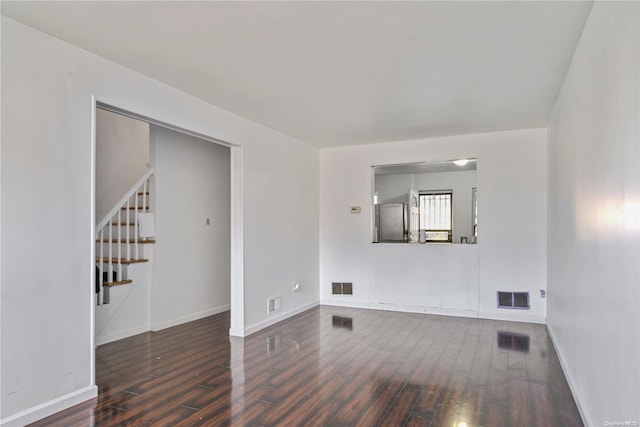 unfurnished living room with dark hardwood / wood-style flooring