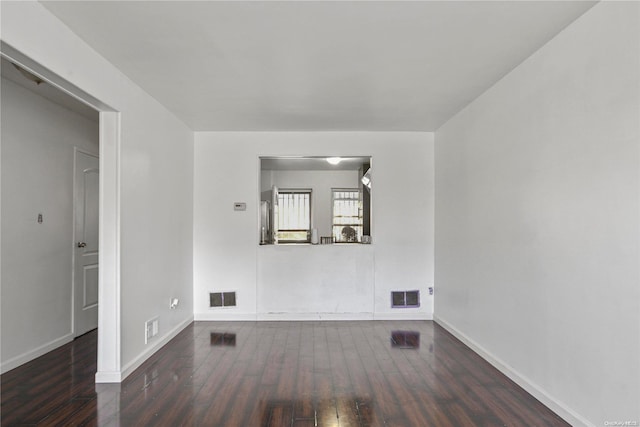 empty room with dark wood-type flooring