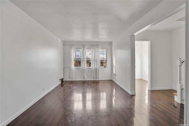 empty room featuring dark wood-type flooring