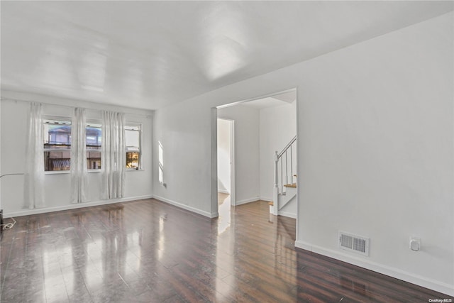 unfurnished room featuring dark wood-type flooring