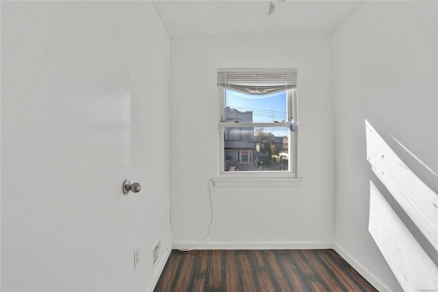 empty room with dark hardwood / wood-style flooring