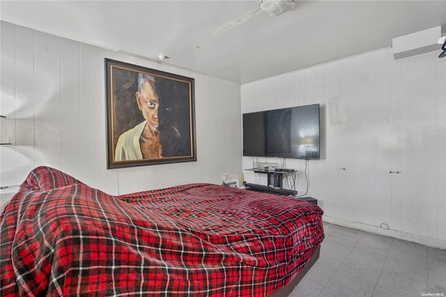 bedroom featuring wooden walls