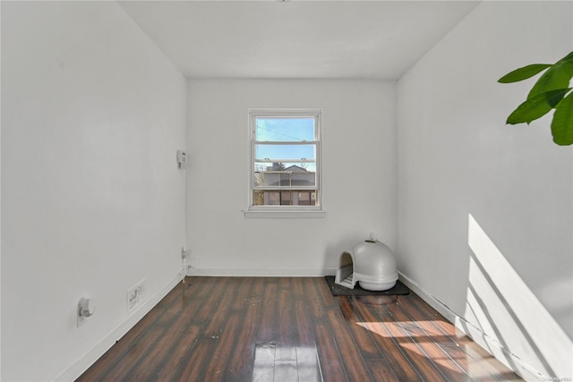 empty room featuring dark wood-type flooring