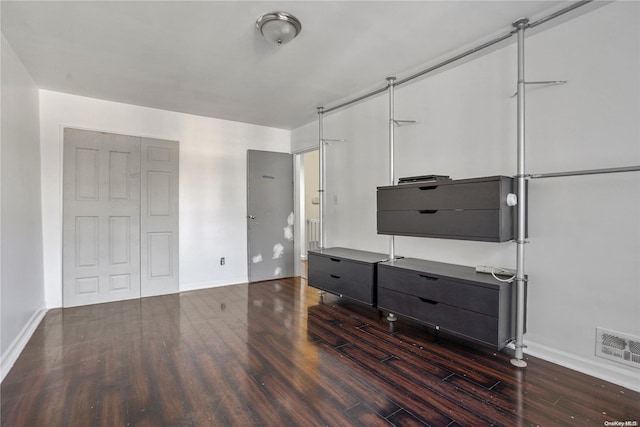 unfurnished living room with dark hardwood / wood-style floors