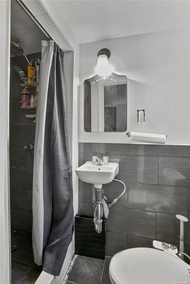 bathroom featuring sink, tile patterned flooring, and toilet