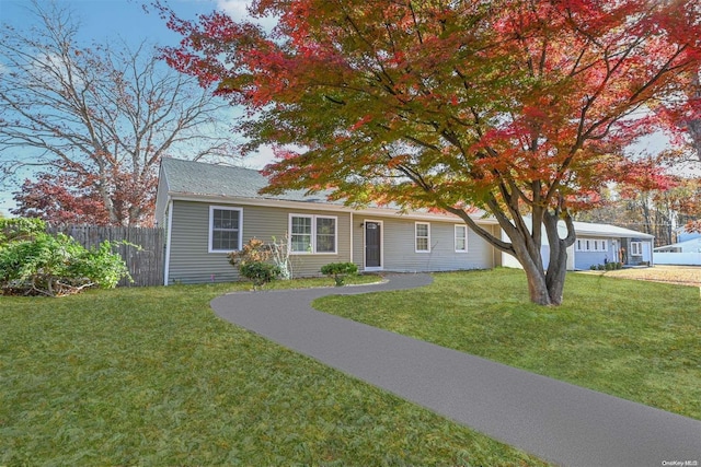 single story home featuring a front lawn