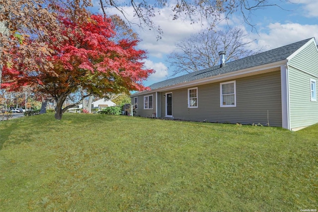 back of house with a lawn