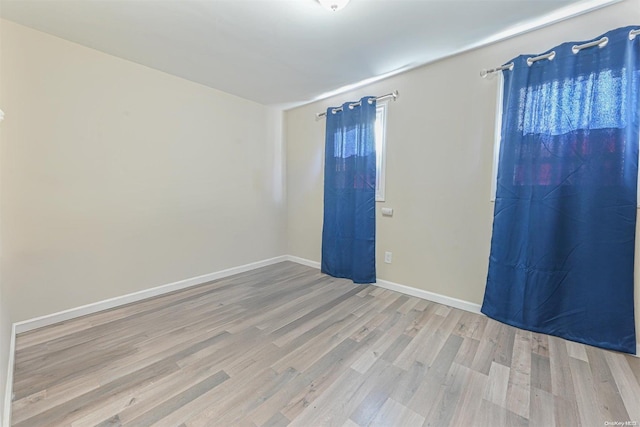 spare room featuring light wood-type flooring