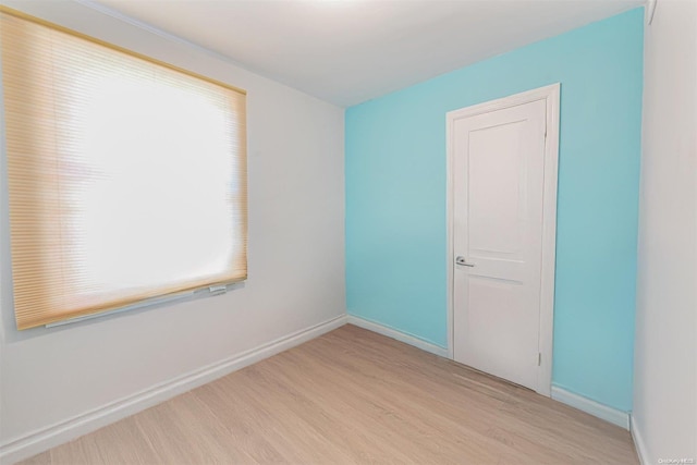 spare room with light hardwood / wood-style flooring