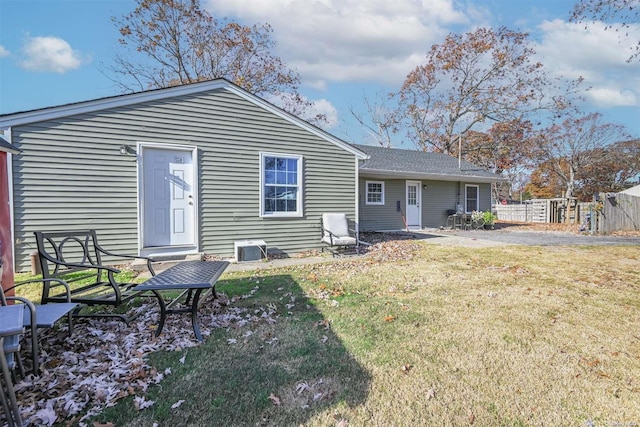 rear view of house featuring a yard