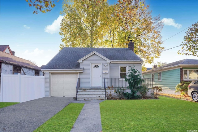 view of front of home featuring a garage and a front lawn