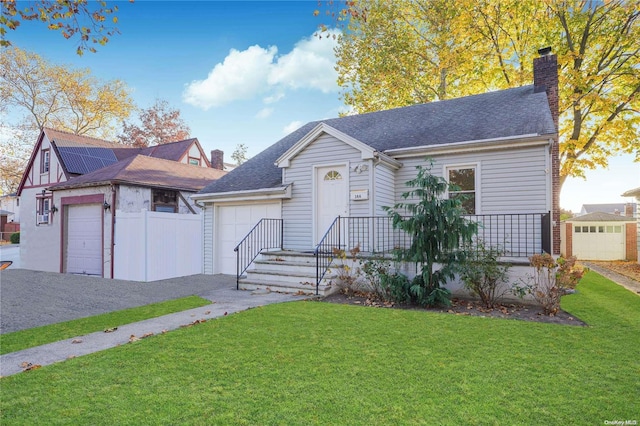 view of front of house with a garage and a front lawn