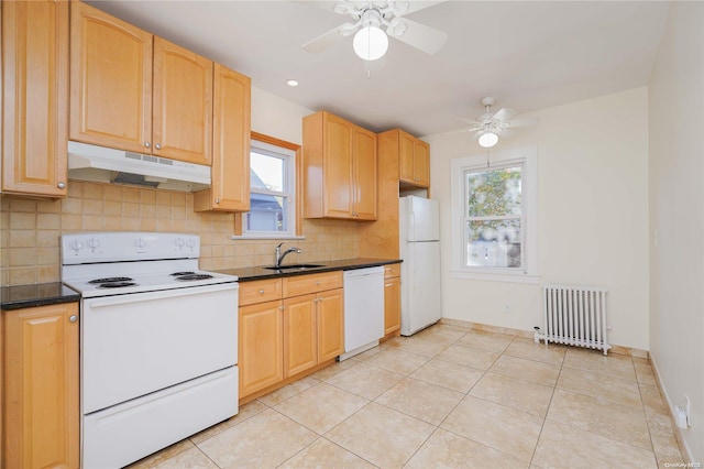 kitchen with tasteful backsplash, radiator heating unit, white appliances, and sink