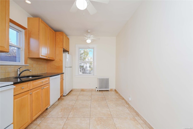 kitchen featuring decorative backsplash, white appliances, ceiling fan, sink, and radiator heating unit