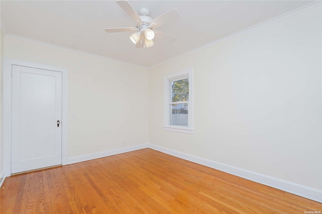 spare room featuring hardwood / wood-style flooring, ceiling fan, and ornamental molding