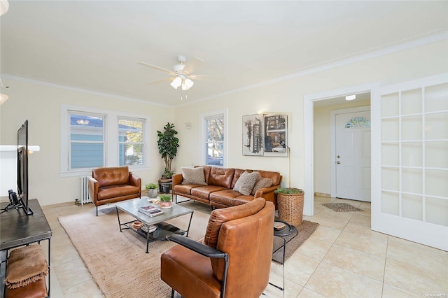 tiled living room with ceiling fan and ornamental molding